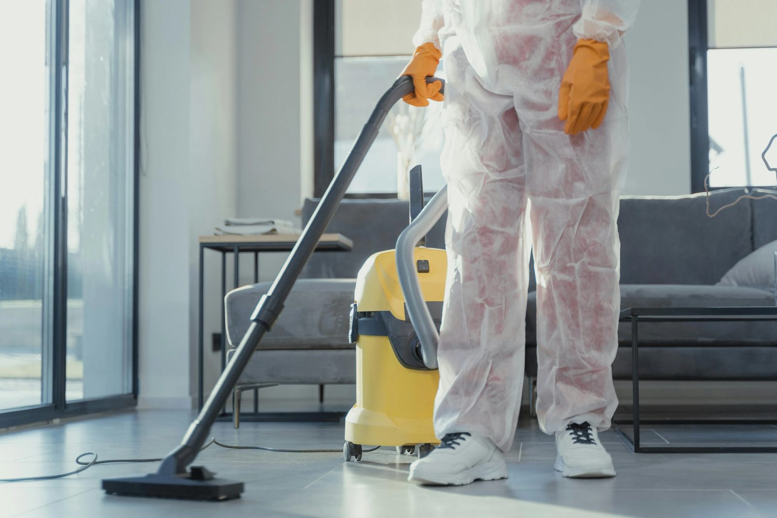 A cleaner using a carpet cleaning machine in a living room