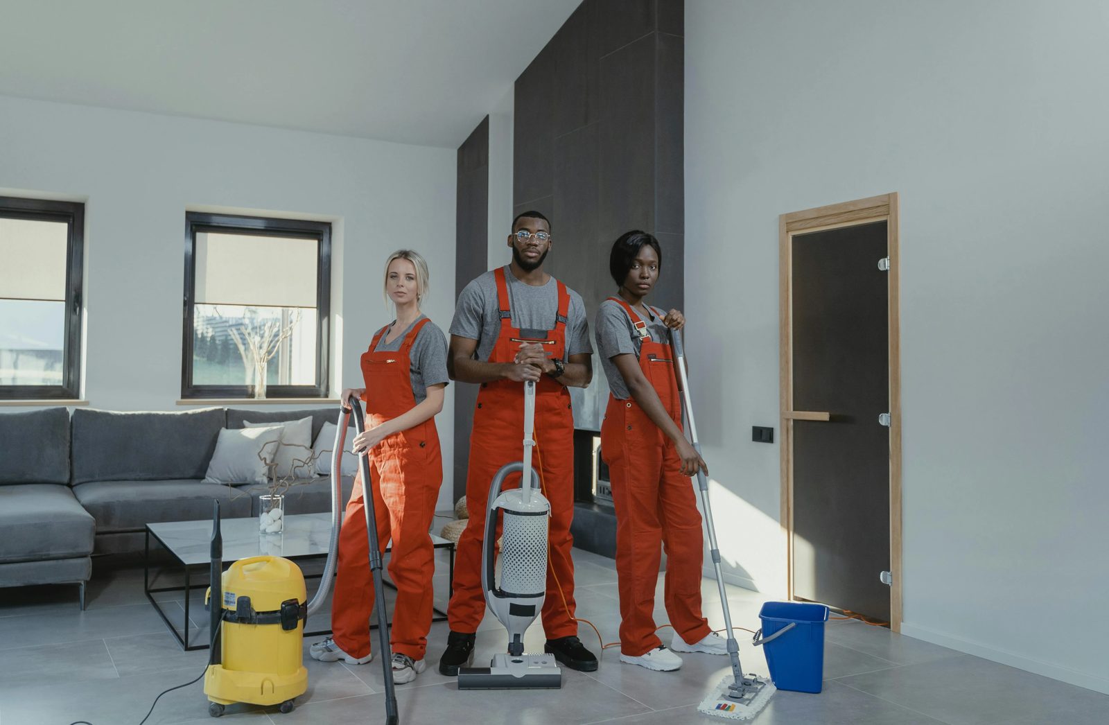 A cleaning team standing in an empty living room
