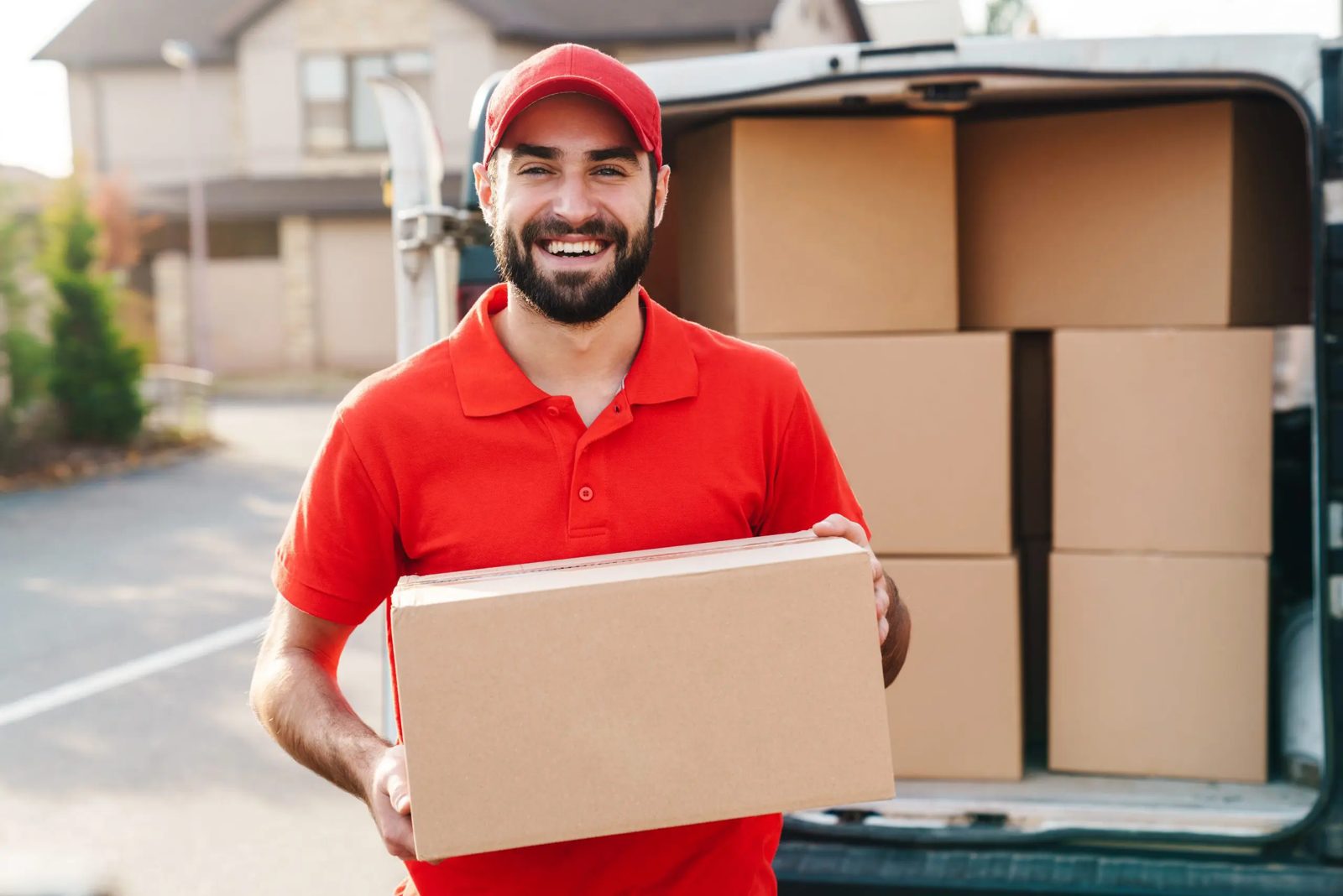 A mover loading labelled boxes into a van